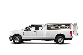 White pickup truck with an extended cab and open truck bed showing organized storage compartments