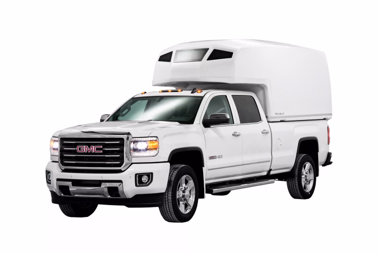 White GMC Sierra 2500HD pickup truck with a large white SpaceKap on the bed