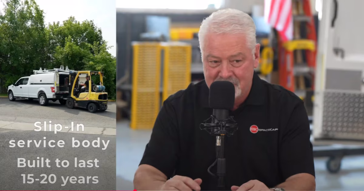 Man speaking into a microphone during a podcast or interview with an image of a slip-in service body truck and forklift in the background
