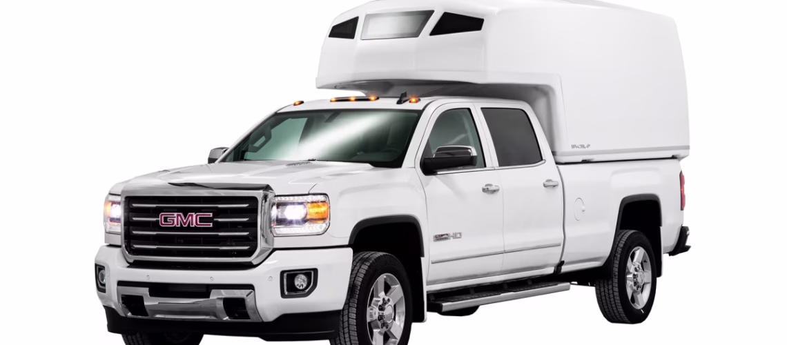 White GMC Sierra 2500HD pickup truck with a large white SpaceKap on the bed